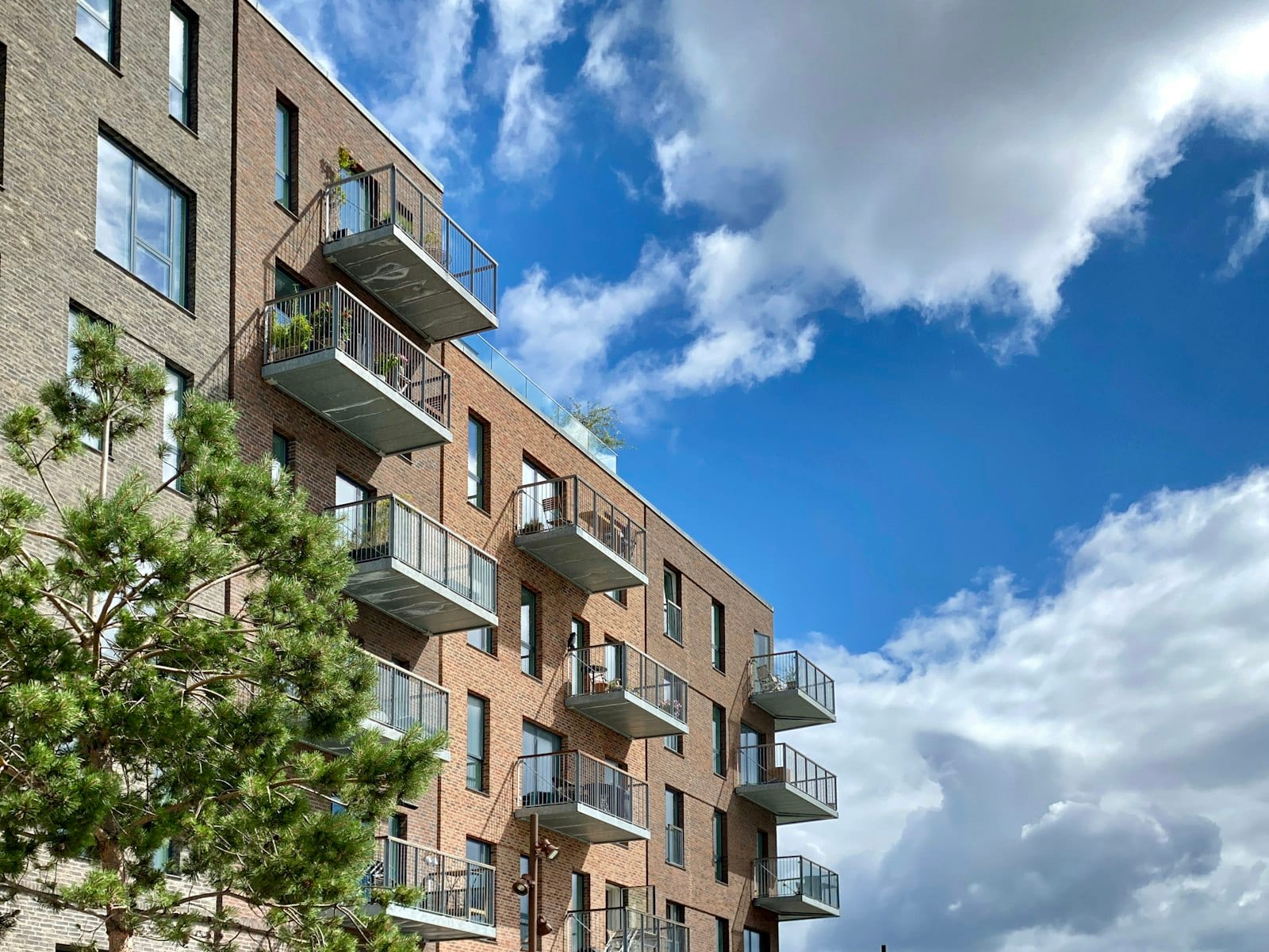 Low-rise brick apartment building with balconies